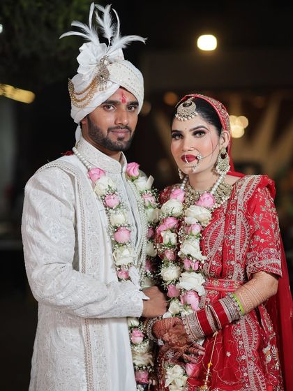 A beautiful couple portrait. I created a classic bridal look with a bold red lip for this Gurjar bride, ensuring she looked radiant.