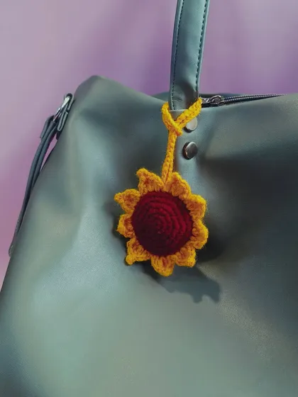 A simple sunflower can brighten anything, including your bag. This crochet sunflower charm is a small but cheerful accessory to add to your collection.