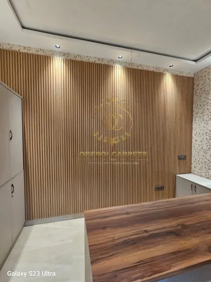 A full accent wall covered in our natural wood-finish WPC louvers. This is a great way to bring warmth and texture into an office or study room, creating a professional yet inviting environment.