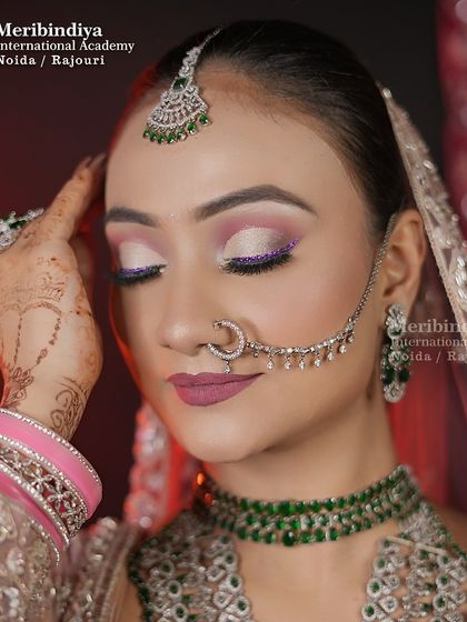 This look features soft, shimmery eye makeup with a pop of purple glitter, paired with a matte mauve lip. It's a perfect example of a modern reception look.