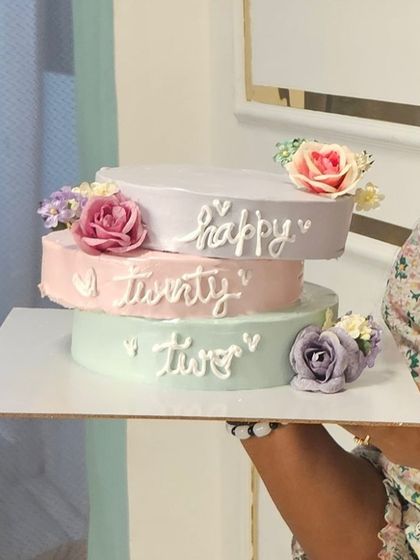 Holding up one of my minimalist mini tier cakes. I love how the simple pastel colors and fresh flowers come together to create something so beautiful.