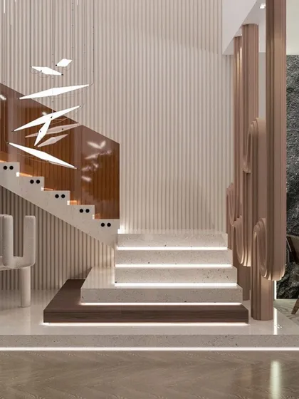 A staircase is more than just a functional element; it's a central feature of a home's interior architecture. This custom-designed staircase combines illuminated marble steps with a unique, artistic wood and glass railing, serving as a sculptural focal point in the residence.