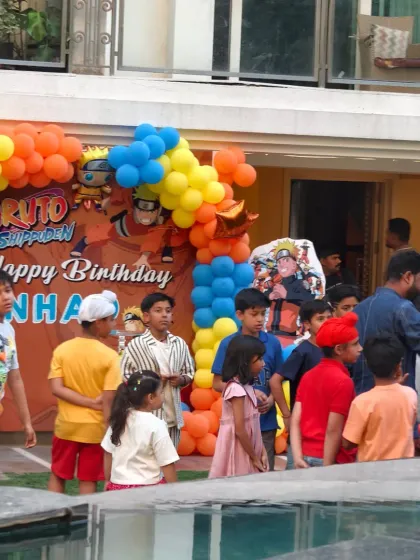 The kids having a great time at the Naruto-themed party, with the decor providing a vibrant backdrop.