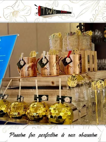 A stylish display of disco ball glasses and copper mugs at an engagement party.