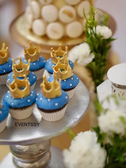 Royal blue cupcakes topped with intricate golden crowns, perfectly matching the prince theme.