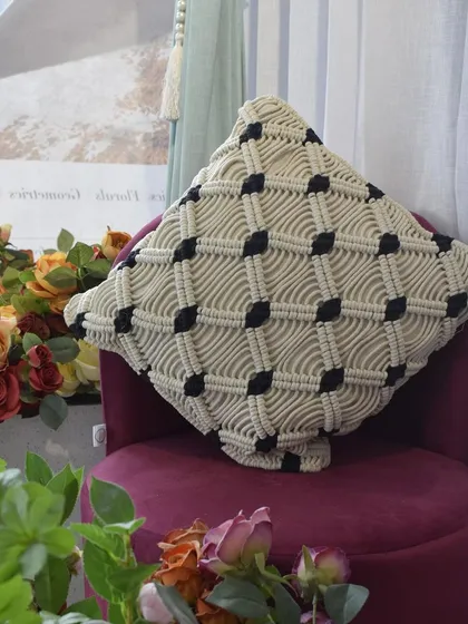 Another angle of the macramé cushion cover, showing how it beautifully catches the light. We can customize colors to match your interior design.