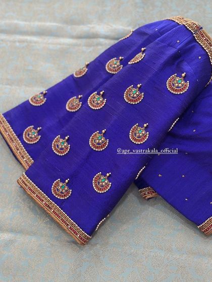 A royal blue blouse with traditional 'chandbali' style embroidery on the sleeves.