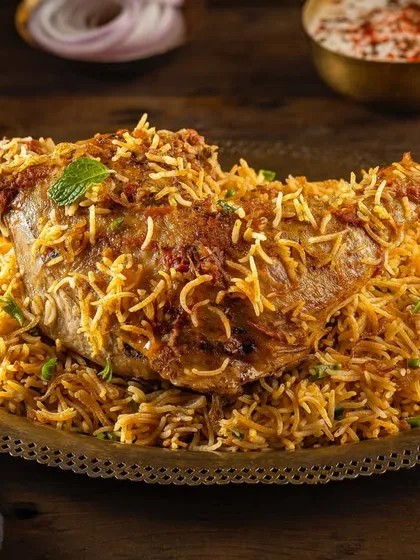 A majestic shot of a whole lamb leg biryani for Punjab Grill. This image was styled to look grand and authentic, capturing the essence of Mughlai and North Indian cuisine for a fine-dining menu.