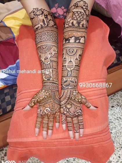 A classic full-hand bridal design featuring traditional Rajasthani elements like elephants, paisleys, and intricate geometric patterns.