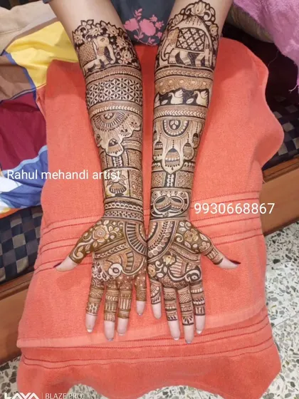 A classic full-hand bridal design featuring traditional Rajasthani elements like elephants, paisleys, and intricate geometric patterns.