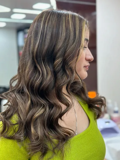 A side profile of the ash blonde look, highlighting the soft waves and the beautiful blend of colors.