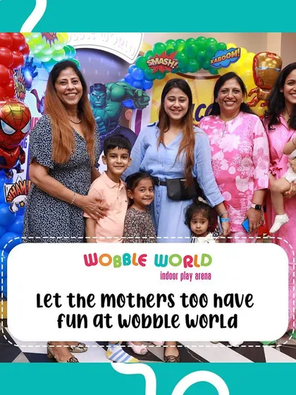We believe moms should have fun too! Here, a group of mothers and their children pose for a happy picture during a party.