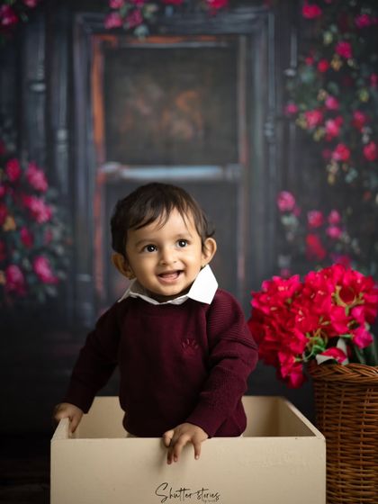 A sweet, curious expression from the toddler in the box, looking off to the side.