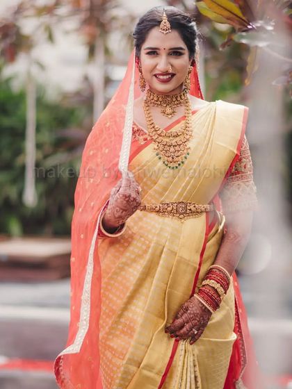 This is a quintessential South Indian muhurtham look. I created a flawless base with a bold red lip for Supritha, which stands out beautifully against her golden silk saree and traditional jewellery. The detailed bridal braid completes this timeless look.