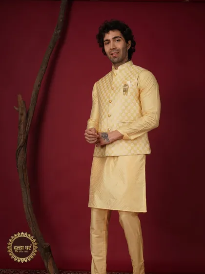 The Ethnic Wear. A full look of a groom in a yellow patterned Nehru jacket and kurta, perfect for a bright and cheerful celebration.