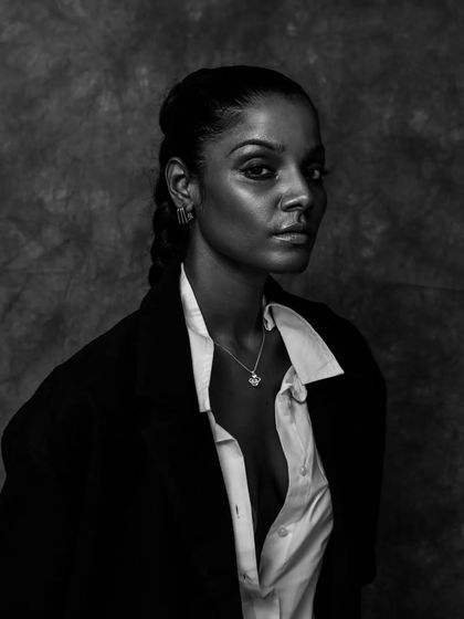 A close-up profile shot in black and white, highlighting the model's features and the stylish layering.