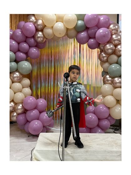 This young Thor delivers his lines with dramatic flair and a powerful stance.