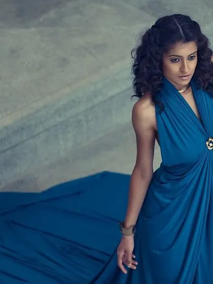 A full look at the draped blue gown. This type of versatile dress can be styled in multiple ways, making it a fantastic piece for a client's wardrobe. Here, it's styled for an elegant, almost Grecian look.