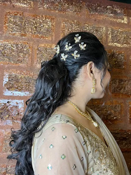 A view from the back, showing the detail of the butterfly clips and the volume of the curls.