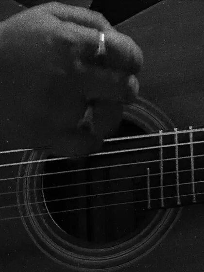 A close-up of my hand and guitar. This is my happy place, where every strum tells a story. This simple setup is all I need to bring music to your cafe, home, or special event.