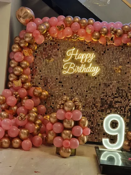 A close-up of the rose gold balloon arch and sequin wall.