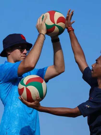 Another angle of a coach demonstrating proper hand positioning for a set. We emphasize precision and technique to ensure every player develops a solid foundation.