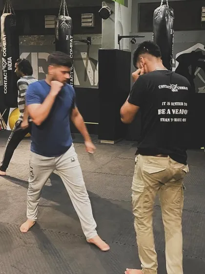 Two students spar, practicing their boxing and defensive movements. This kind of live drilling is essential for learning timing, distance, and how to read an opponent.