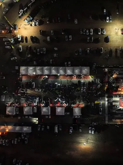 A closer top-down shot of the expo area, buzzing with activity even after the sun goes down. The energy at Vroom never stops.