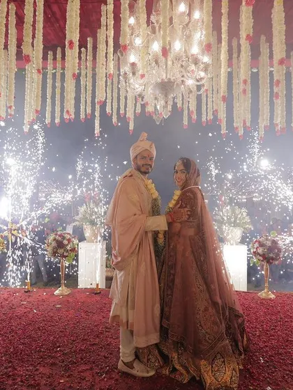 A beautiful shot of the couple during their varmala ceremony, framed by an explosion of sparklers. I use special effects to elevate traditional rituals into cinematic moments.