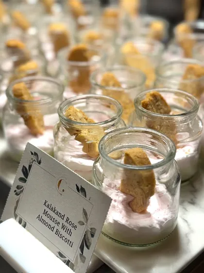 Kalakand Rose Mousse with Almond Biscotti, served in individual glass jars. This dessert beautifully marries the Indian flavour of Kalakand with a light mousse texture and a crunchy Italian biscuit.