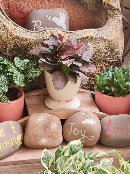 Weekend vibes! These cute, hand-painted pebbles add a personal and positive touch to any plant arrangement. It's the little details that bring joy.