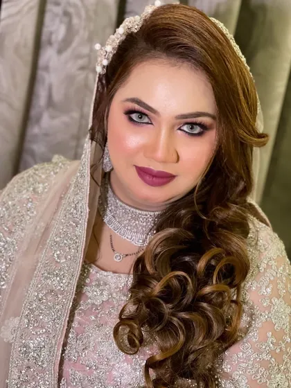 A beautiful Walima look. The bride is wearing a stunning silver and pink outfit, and I created a dramatic smokey eye with a bold berry lip to match.
