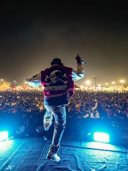 On the edge of the stage, hyping up a massive festival crowd. I'm not just behind the decks; I'm part of the show.