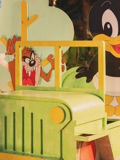 A fun prop of baby Daffy Duck and the Tasmanian Devil in a green jeep.