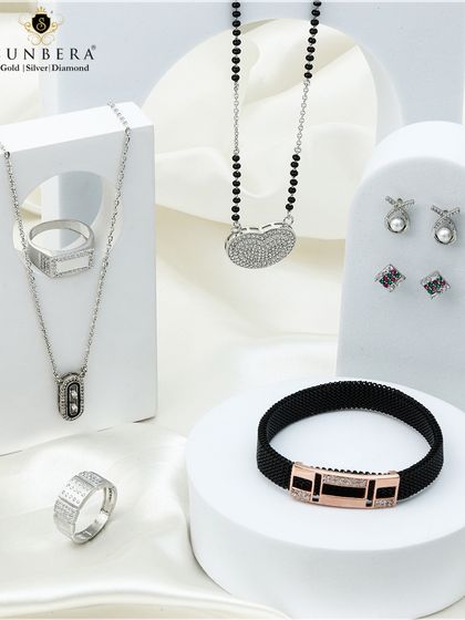 Handcrafted silver jewellery sets designed to complement your grace. This image shows a modern mangalsutra, a men's bracelet, and delicate earrings.