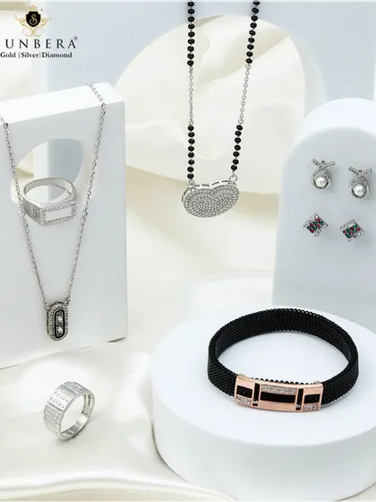 Handcrafted silver jewellery sets designed to complement your grace. This image shows a modern mangalsutra, a men's bracelet, and delicate earrings.