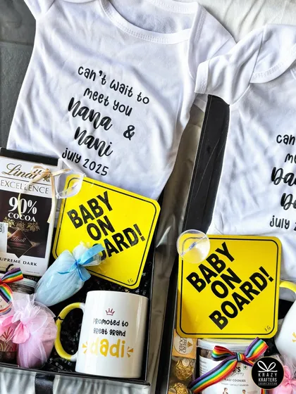 This hamper combines a personalized onesie, a 'Baby on Board' sign, and other goodies for a client's family announcement. It's a complete package of joy.