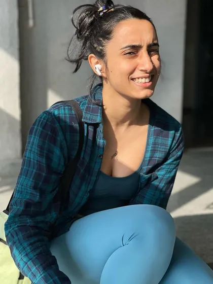 A candid smile while taking a break. Finding joy in the small moments is just as important as the big workouts.