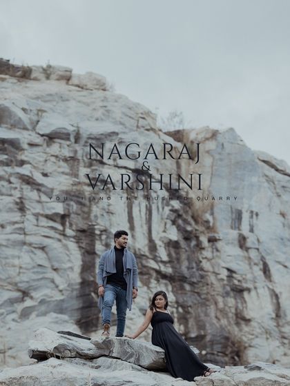 A striking pre-wedding portrait of a couple against the vast, dramatic backdrop of a stone quarry.