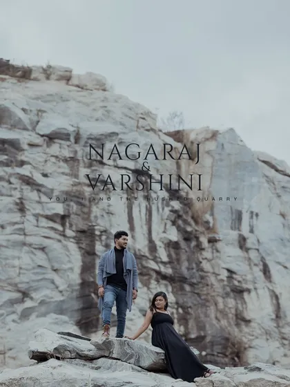 A striking pre-wedding portrait of a couple against the vast, dramatic backdrop of a stone quarry.