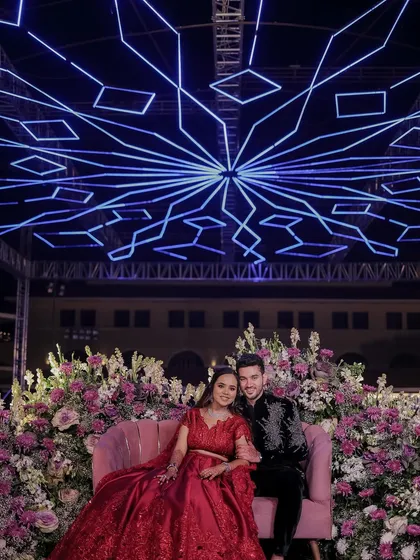 Sangeet glam with a touch of drama. This couple shot showcases the bride's stunning red ensemble, complemented by smokey eyes and a radiant complexion.