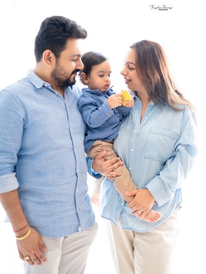 A candid family portrait where the focus is on the little boy and his toy. These simple, everyday moments make for beautiful and authentic photographs.