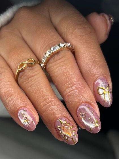 This shot highlights the variety of hand-painted gold designs in this set, including a radiant sun and a delicate bow.