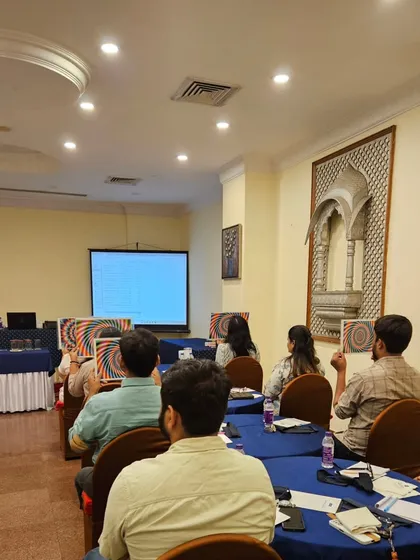 Participants at my workshop holding up charts used for a focus and concentration exercise. These practical tools help in activating the Ajna chakra.