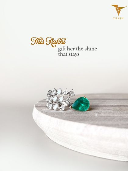 This Rakhi, gift her the shine that stays. This unique ring, featuring a pear-cut emerald and a cascade of diamonds, is a brilliant way to celebrate her.