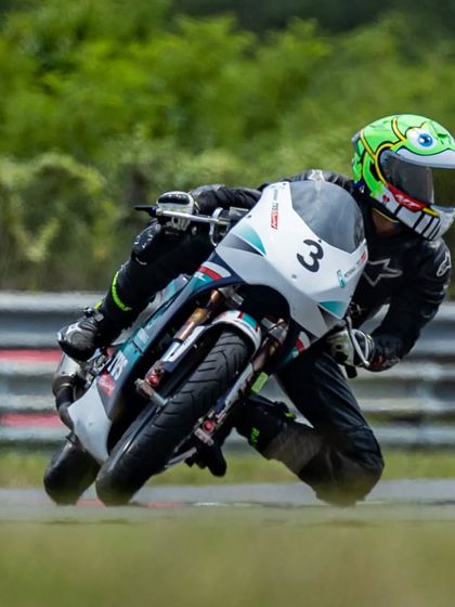 Our rookie rider Aaron Soni Fernandez, in his distinctive frog-themed helmet, leans his Petronas TVS race bike into a corner. His performance earned him a solid points finish in the championship.