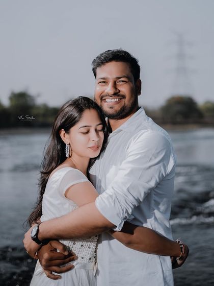 A warm and happy embrace by the water. His big smile shows the joy of the moment, making for a wonderful and genuine candid portrait.