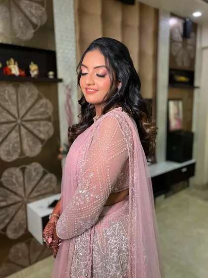 A side profile showing the soft curls and glowing highlight. The makeup is blended seamlessly for a flawless finish.