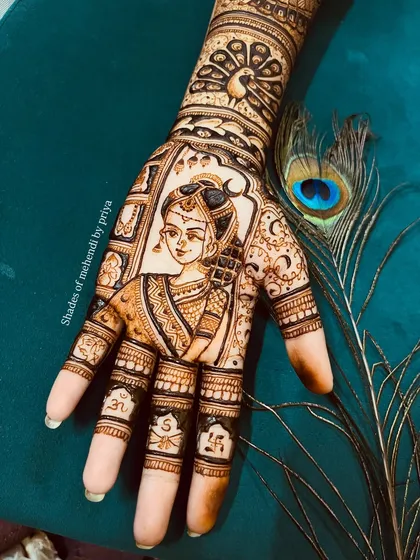 A beautiful portrait of a bride on the palm, framed by intricate patterns. A peacock feather is placed next to the hand, complementing the traditional aesthetic of the design.