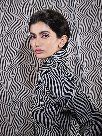Another angle from the print-on-print shoot, highlighting the sharp pink winged liner and the retro-inspired hairstyle.